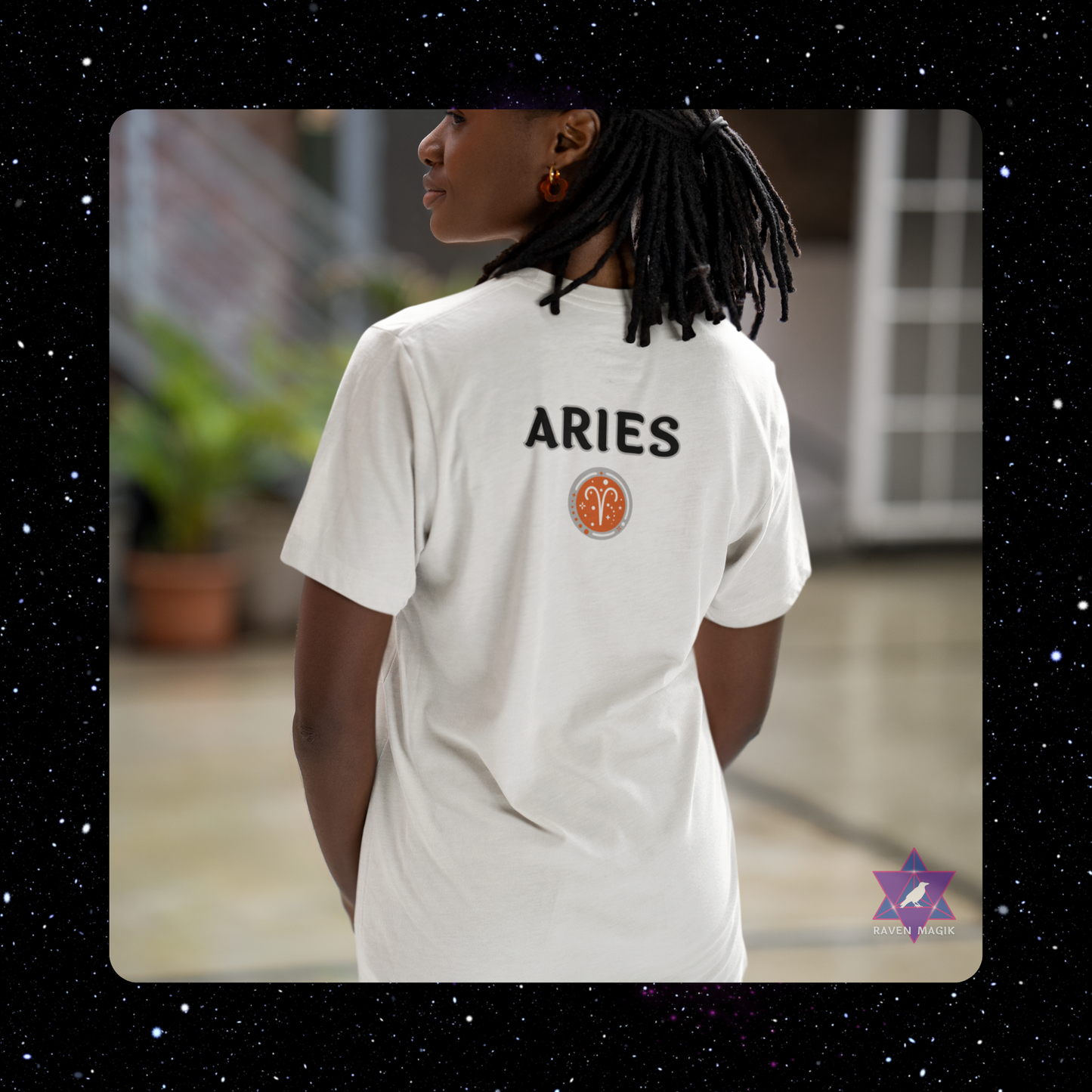 Person wearing a white t-shirt with 'ARIES' text and logo, standing outdoors.