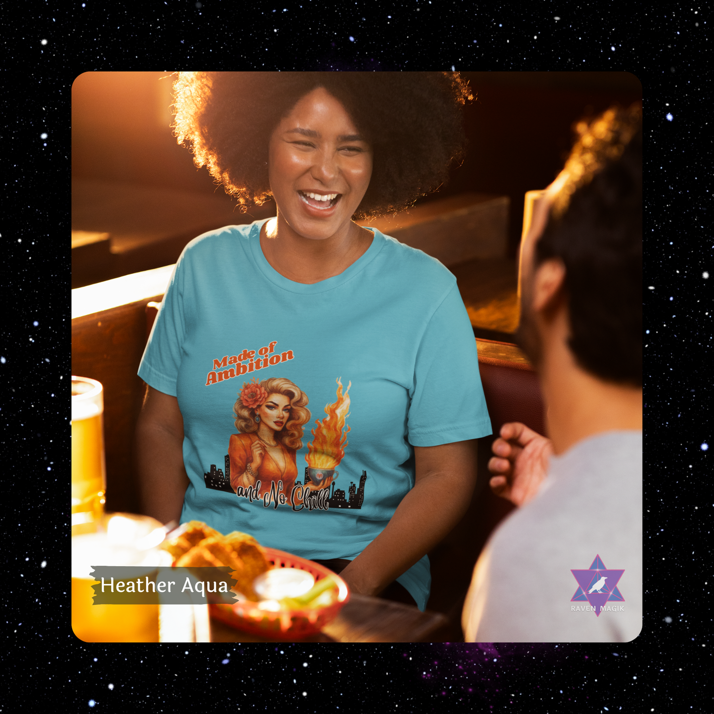 Person wearing a blue t-shirt with a graphic design, sitting at a table with food and drinks. Aries Zodiac T-shirt with “Made of Ambition and No Chill” slogan, styled for fiery, unapologetic energy. Heather Aqua Color Shirt.