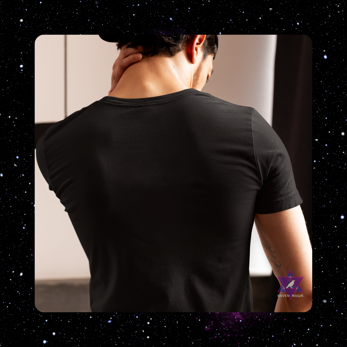 Person wearing a black t-shirt with a starry night background