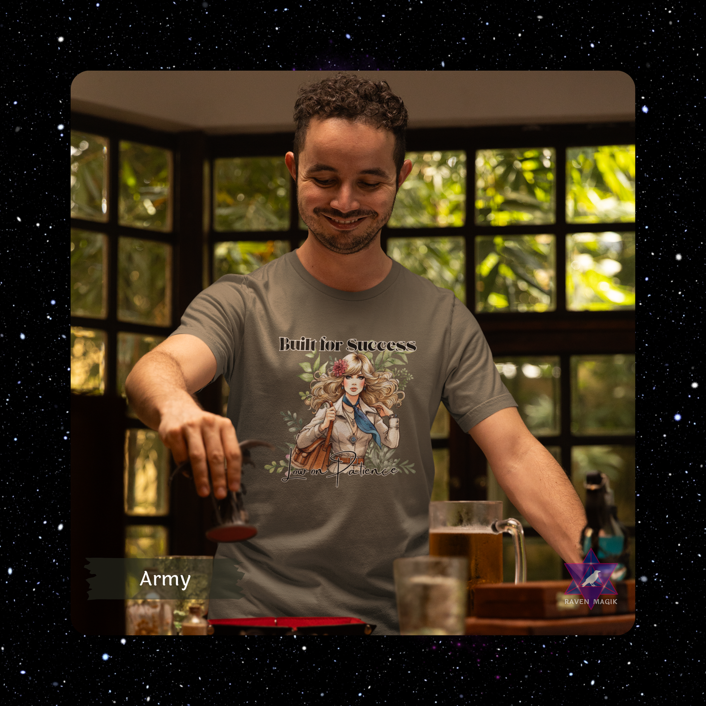 Man wearing a t-shirt with a graphic design, standing in front of a window with greenery. Capricorn Archetype T-shirt with “Built for Success and Low on Patience” slogan, styled for ambitious, efficient energy and unapologetic drive.