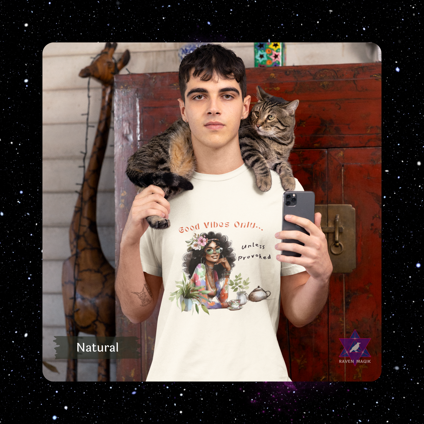 Person holding a cat and taking a selfie with a t-shirt featuring a graphic design. Gemini Archetype T-shirt with “Good Vibes Only… Unless Provoked” slogan, styled for expressive, unpredictable energy and dual-natured charm.
