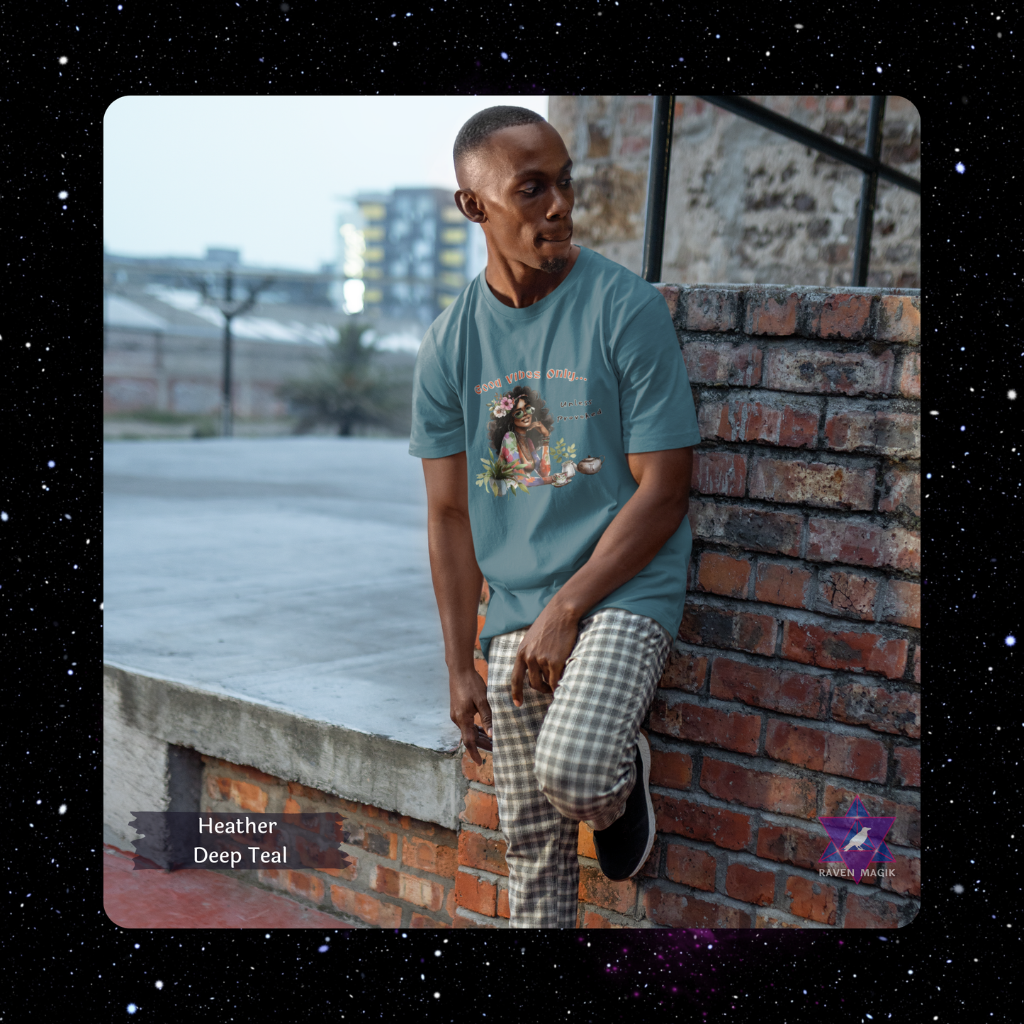 Man wearing a teal t-shirt leaning against a brick wall with a cityscape in the background. Gemini Zodiac T-shirt with “Good Vibes Only – Unless Provoked” slogan, styled for playful, expressive energy.