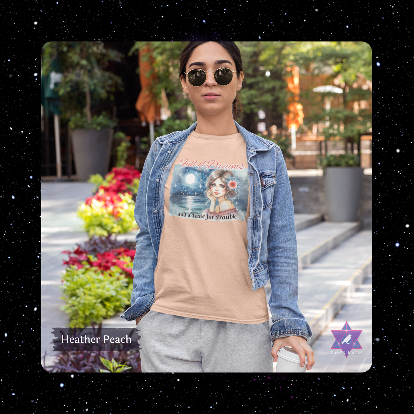Woman wearing a beige t-shirt with a graphic design outdoors. Pisces Archetype T-shirt with “Full of Dreams and a Taste for Trouble” slogan, styled for intuitive, whimsical energy and poetic rebellion.
