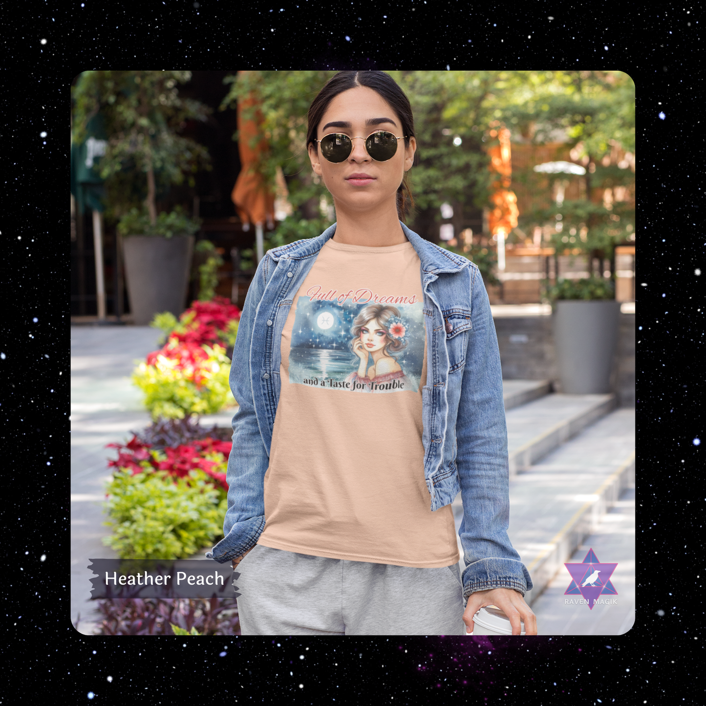 Woman wearing a Heather Peach t-shirt with a graphic design and denim jacket outdoors. Pisces Zodiac T-shirt with “Full of Dreams and a Taste for Trouble” slogan, styled for whimsical, empathic energy.