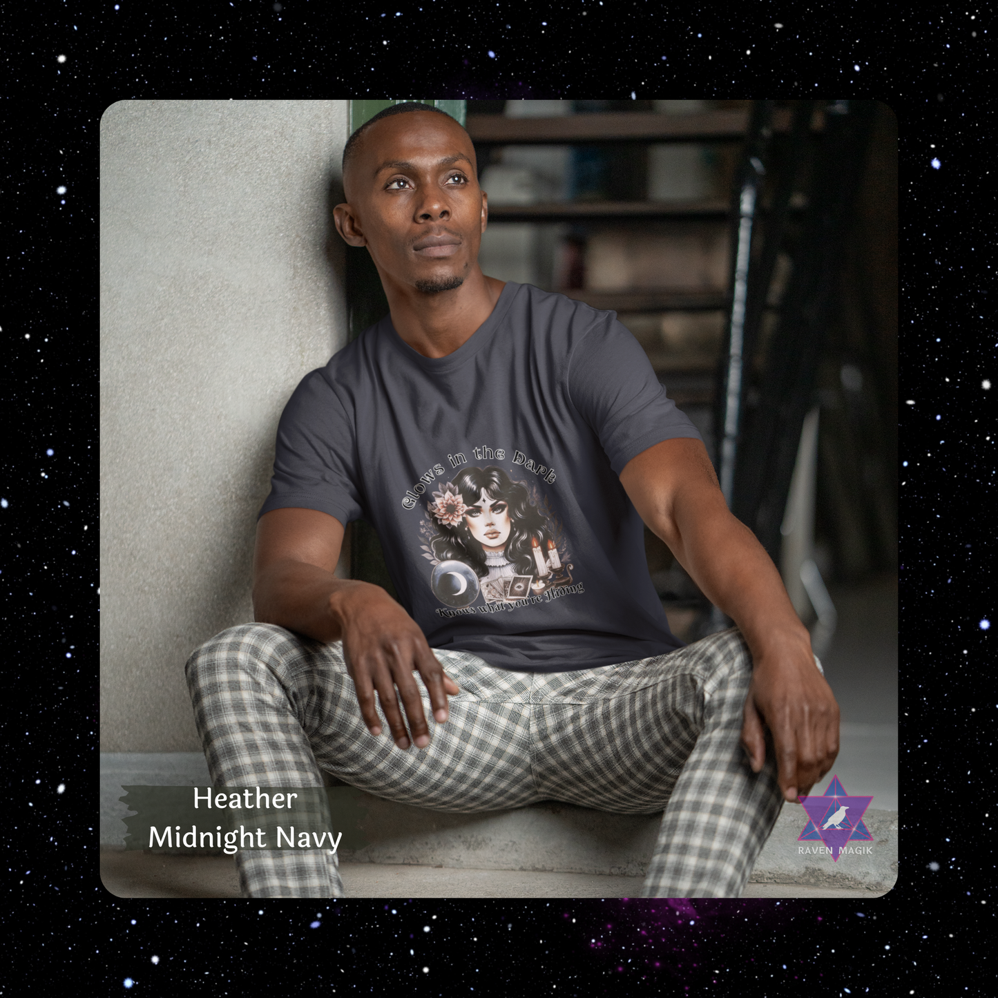 Man wearing a graphic t-shirt and checkered pants sitting on a step. Scorpio Archetype T-shirt with “Glows in the Dark and Knows What You’re Hiding” slogan, styled for mysterious, magnetic energy and shadowy charm.