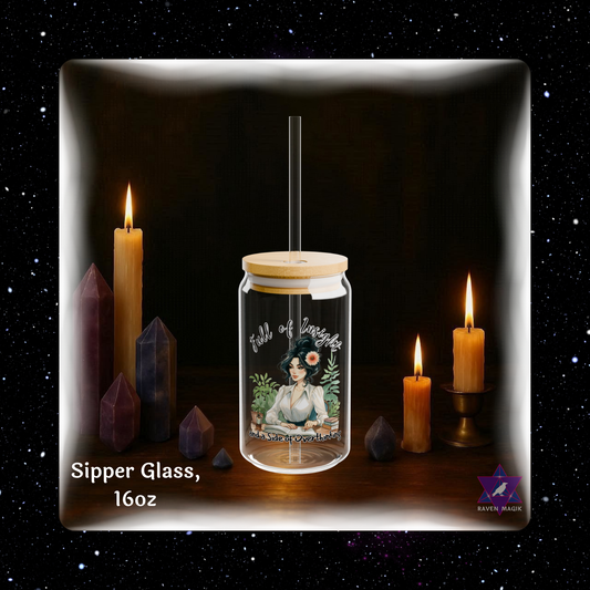 Glass sipper with a design of a person sitting in nature, surrounded by candles and crystals on a dark background.
