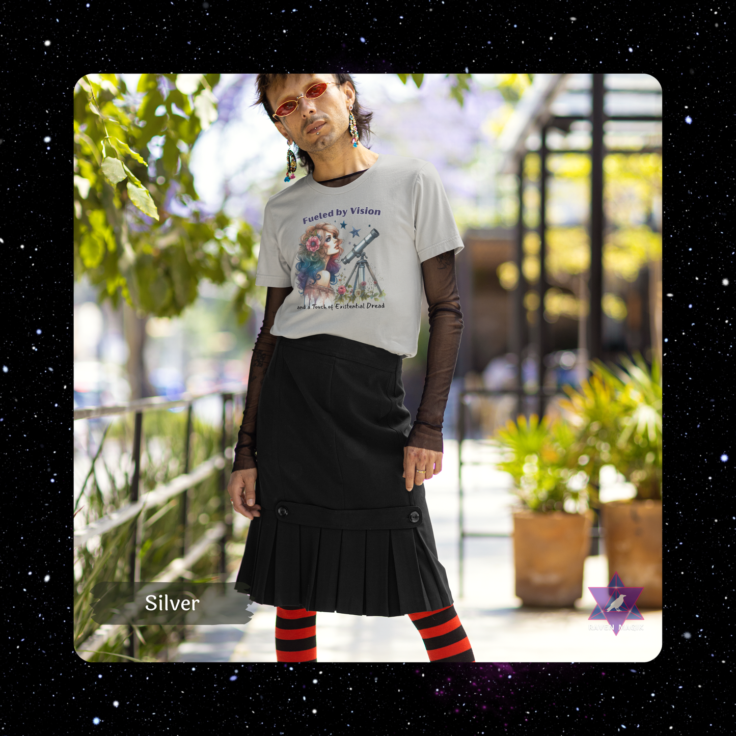 Person wearing a graphic t-shirt and black pleated skirt outdoors with plants and a building in the background. Aquarius Archetype T-shirt with “Fueled by Vision and Existential Dread” slogan, styled for eccentric, future-forward energy and emotionally unavailable charm.