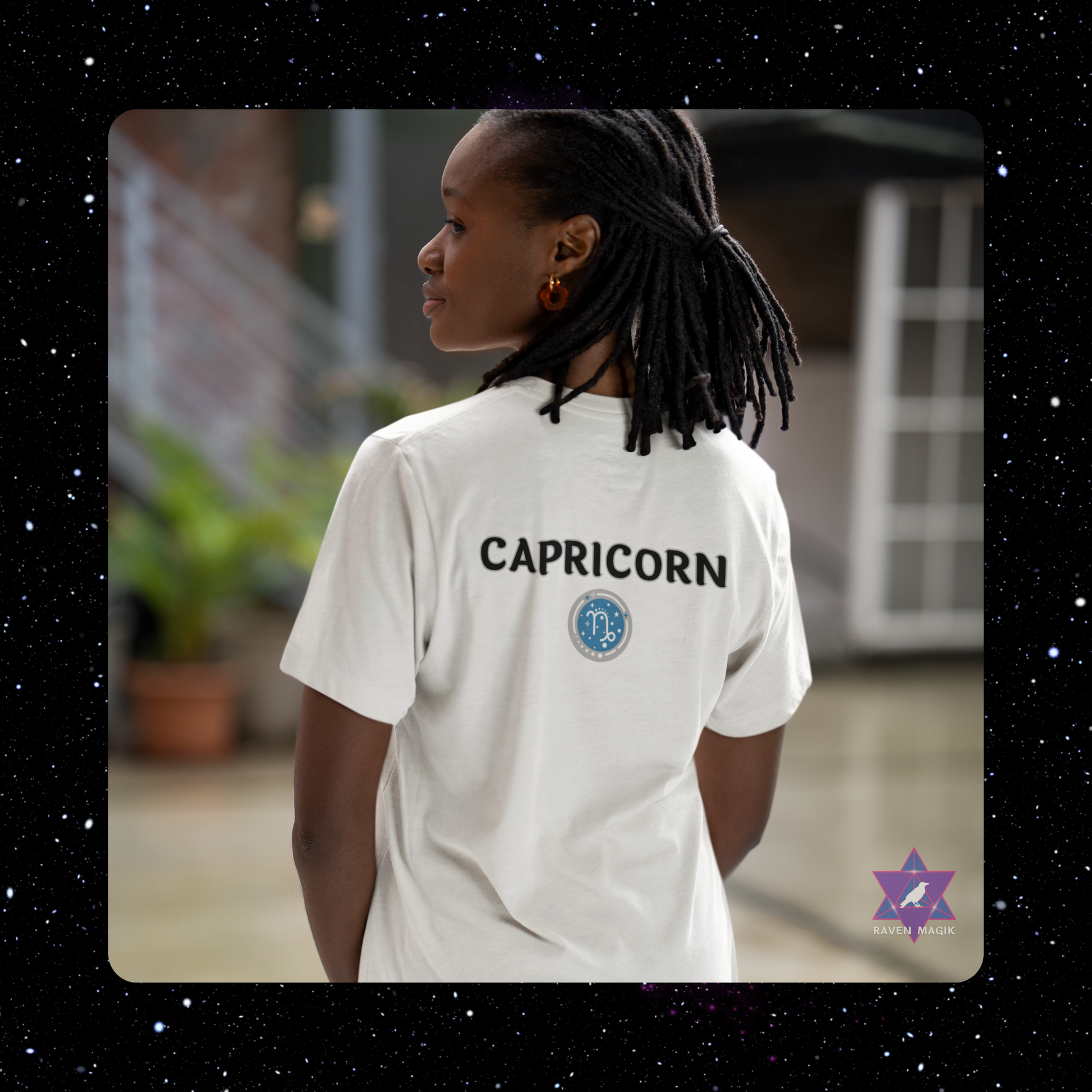 Person wearing a white t-shirt with 'Capricorn' printed on it, standing outdoors.
